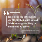 Zitat: "Jeder neue Tag schenkt uns die Möglichkeit, mit Mut und Stärke den eigenen Weg zu finden und zu gehen." - Roswitha Ganseneder-Lotter. Auf Schneeglöckchen-Hintergrund.