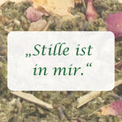 Affirmation "Stille ist in mir" auf Hintergrund aus Kräutern und Rosenblüten der Räuchermischung.