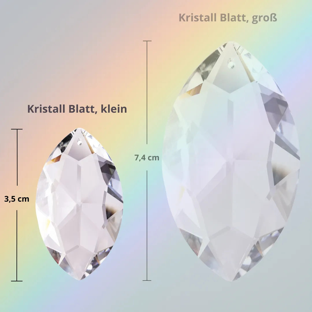 Kleiner Sonnenfänger Kristall in Blattform (3,5 cm), im Größenvergleich mit größerem Blatt, für harmonische Atmosphäre und Regenbögen.