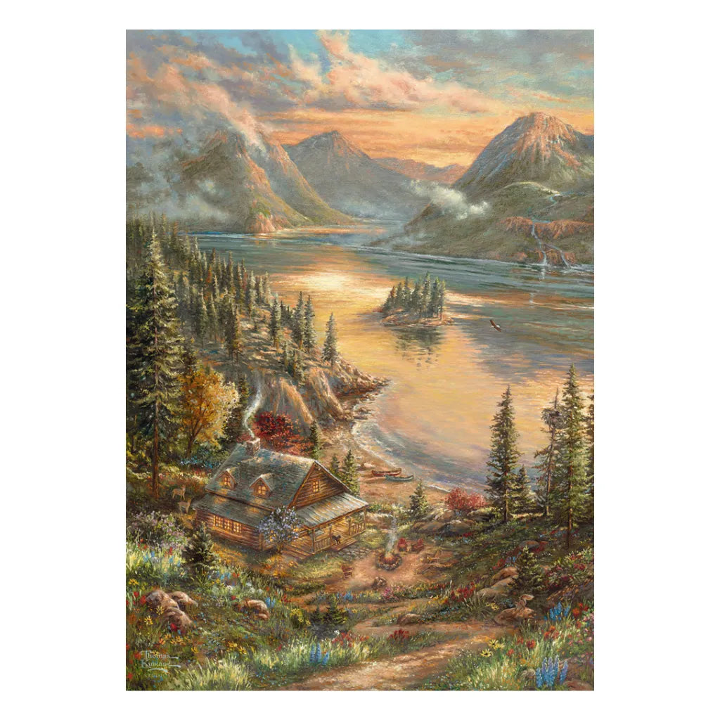 Detailliertes Motiv des Schmidt Puzzles 500 Teile "Pracht am Seeufer" von Thomas Kinkade. Eine friedliche Landschaft am See mit einer beleuchteten Hütte, hohen Bergen, dichten Nadelbäumen und warmem Abendlicht.