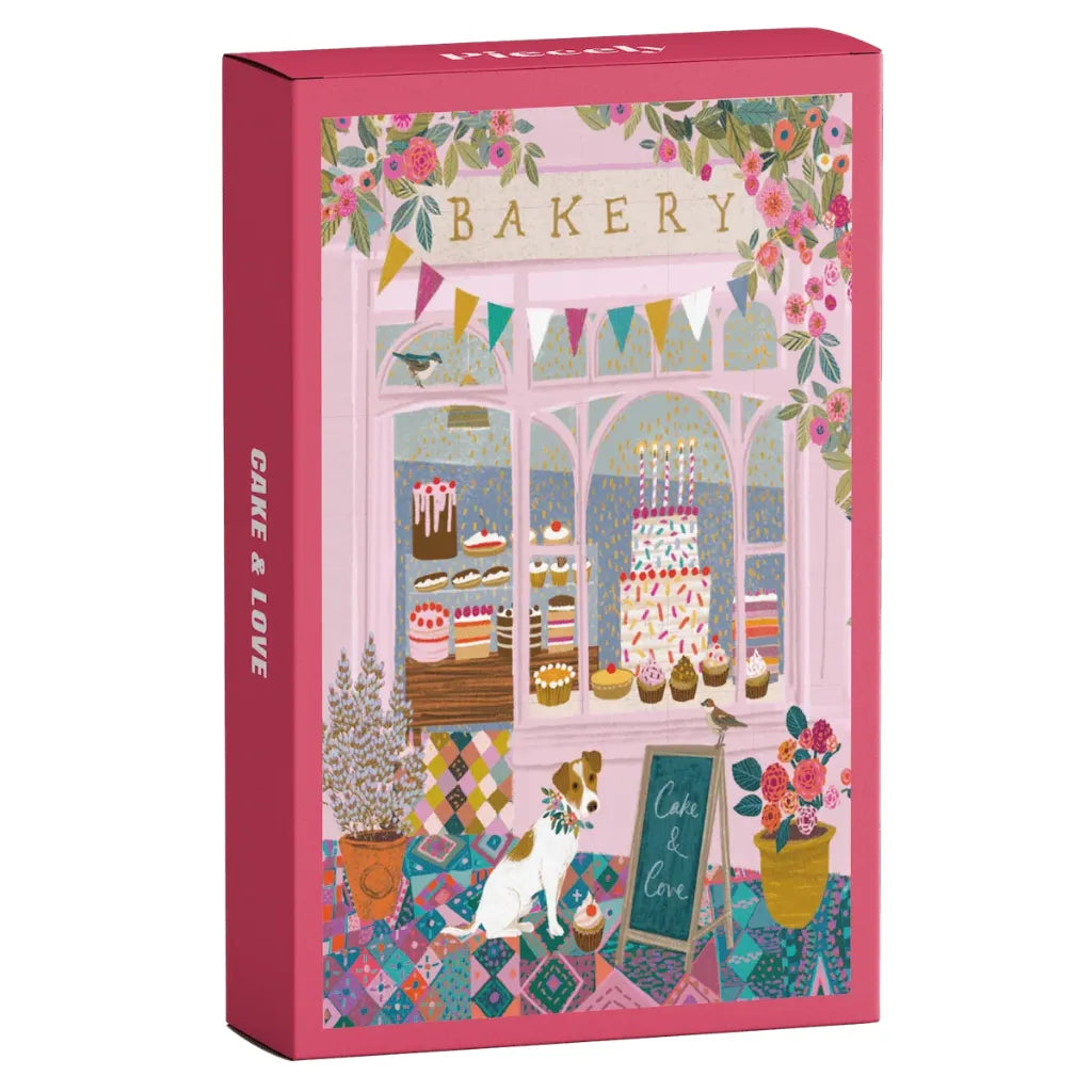 Piecely Minipuzzle 99 Teile "Cake & Love" Produktverpackung. Zeigt eine charmante Bäckerei-Fassade mit einem Hund, bunten Torten und festlicher Blumendekoration.