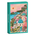 Frontansicht der Piecely Minipuzzle 99 Teile "Santorini Sun" Verpackung. Das Design zeigt die charmante Darstellung von Santorini mit seinen pastellfarbenen Häusern und dem blauen Meer.