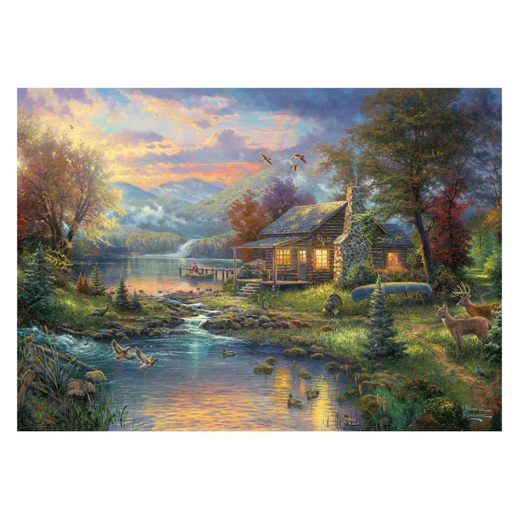 Detailliertes Motiv des Thomas Kinkade 500 Teile Puzzles "Nature's Paradise". Eine beleuchtete Waldhütte an einem Bach, umgeben von Hirschen und Enten in einer Berglandschaft.